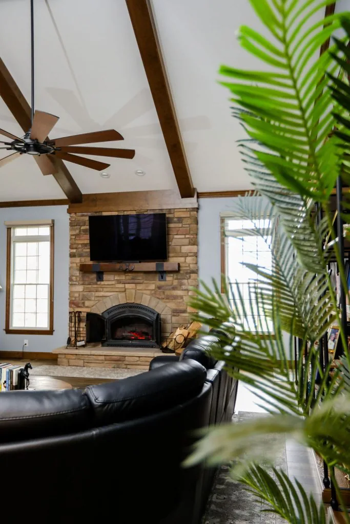 Living room with floor-to-ceiling stone fireplace by Padgett