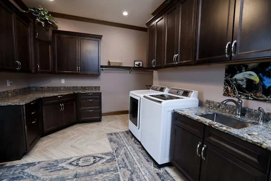 Custom kitchen with dark cabinetry and island by Padgett
