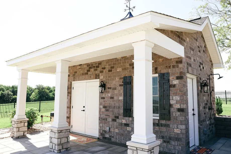 Covered outdoor patio with stone columns by Padgett
