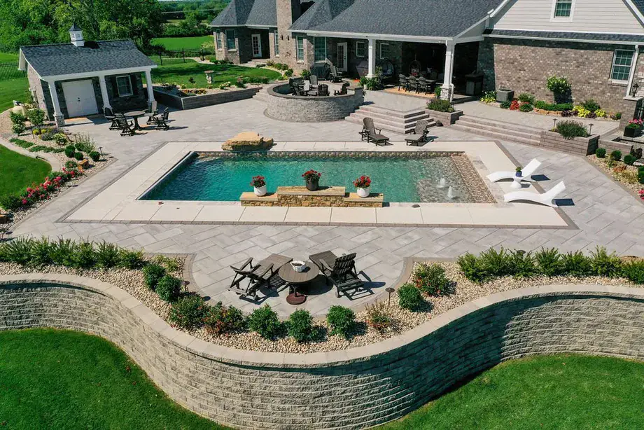 Backyard with custom stamped-concrete patio and pool by Padgett