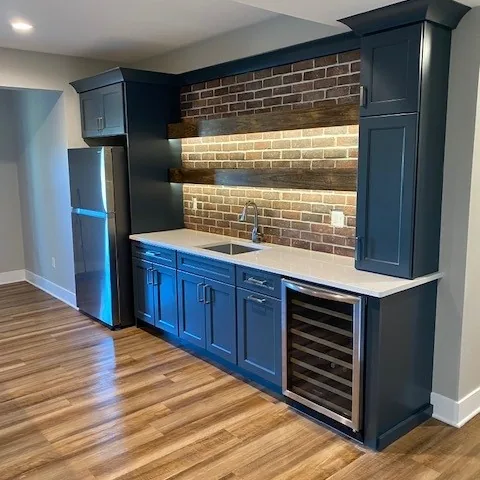 Finished basement with custom bar and lighting by Padgett
