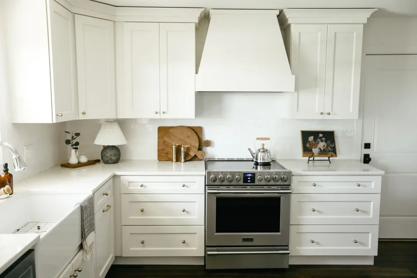 White shaker kitchen with custom range hood remodeled by Padgett